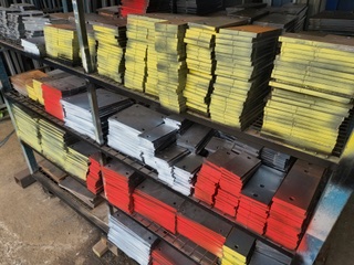 Painted flat bar rack in colour-coded sizes at Marshall Steel