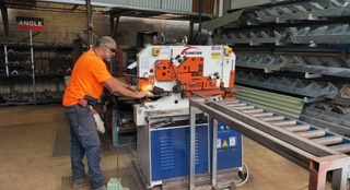 Marshall Steel yardhand cutting steel to length on the coldcut saw