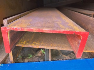 Red end-cap RHS beam close-up at Marshall Steel