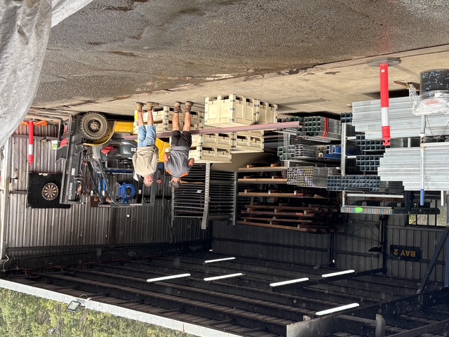 Bay 2 at the yard — team loading pallets beside the forklift
