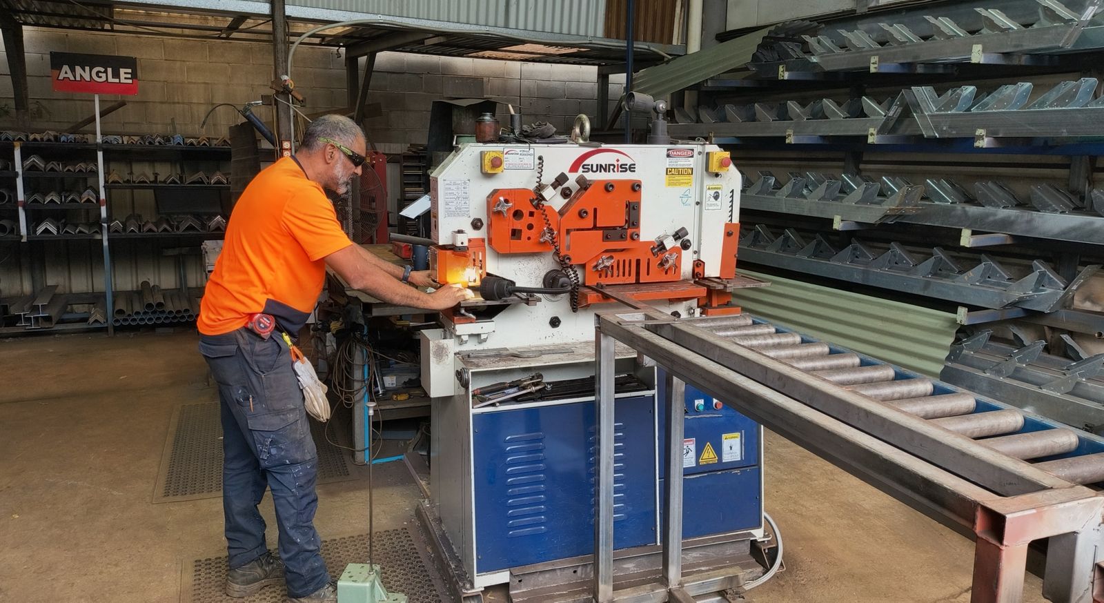 Derek at the Sunrise ironworker punching angle at the Marshall Steel workshop
