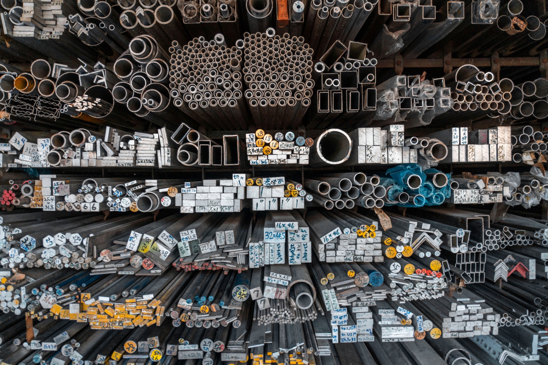 Steel off-cuts, drops and short lengths sorted by size at the Marshall Steel yard — pipe, tube, bar and angle