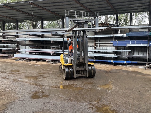 Pete on the forklift carrying steel across the Marshall Steel Burleigh Heads yard
